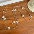 Detailed view of elegant long necklace with pearl flower charms and silver beads. - Rope Necklace