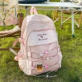 Large capacity pink student backpack featuring a cute cat keychain and mesh pocket detail - With Pendant / Pink
