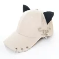 Detail view of beige baseball cap featuring black cat ears, metal rings and punk safety pin. - Adult 55-58cm / Safety Pin Snake Beige