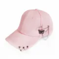 Pink baseball cap detail view, featuring metal rings on brim and butterfly chain side decor. - Pink Butterfly Pin