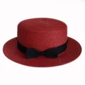 Detailed view of the red straw hat featuring a black ribbon bow and fine woven texture. - Adult 55-58cm / Bow Red
