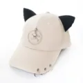 Vue détaillée d'une casquette beige avec oreilles de chat, pendentif crâne et anneaux - Adulte 55-58cm / Style avec décoration de crâne / Beige