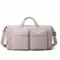 Large capacity foldable travel duffel bag with front pockets and shoulder strap detail. - Soft Pink