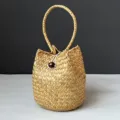 Close-up detail of the natural weave and bead closure on a handmade seagrass bag - Snail Bucket Basket