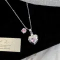 Detailed close-up of heart-shaped pendant with sparkling pink zircon and star accents - Pink Heart Necklace (R5737)