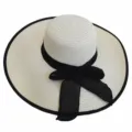 Detailed view of a cream straw sun hat featuring a large brim and a black mesh bow accent - Adult 55-58cm / Cream with Black Trim
