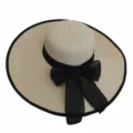Detailed macro shot of the black ribbon bow and woven texture on this wide brim straw sun hat - Adult 55-58cm / Beige Black Trim