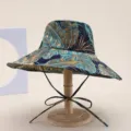 Detailed view of tropical print bucket hat, lightweight foldable sun protection beach cap. - Blue Leaf