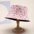 Detailed view of a reversible floral bucket hat with cherry blossom print on a wooden stand - 粉色写实樱花印花