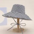 Close-up of black and white polka dot wide brim sun hat detail, stylish summer fashion beach. - White Polka Dot