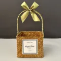 Macro detail of a handmade square woven straw gift basket with a green silk ribbon bow - Small (15*15*12) / Orange Basket (Moss Green Ribbon)