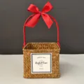 Macro view of woven square gift basket featuring a festive red ribbon handle - Small (15*15*12) / Orange Basket (Wine Red Ribbon)