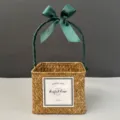 Detail of square hand-woven straw gift basket featuring an elegant green satin ribbon bow - Orange Basket (Dark Green Ribbon)