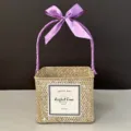 Macro view of woven square gift basket with purple ribbon handle and special gift label - Whitewashed Basket (Grape Purple Ribbon)