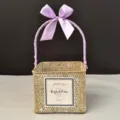 Detailed view of square woven gift basket with purple ribbon bow handle - White-Washed Basket [Coral Purple]