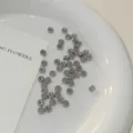 Shiny silver stainless steel round ear bone studs displayed on a white plate. - 10 Pieces/Pack