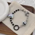 Close-up of butterfly phone charm with hand-painted beads and black donut ring - Butterfly Black (R2961) / Black