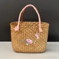 Woven straw basket detail showing pink ribbon handle and elegant plum blossom embroidery. - 30x14x21cm / Peach Blossom Embroidered Style (DIY Ribbon)
