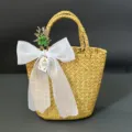 Handmade straw woven basket detail featuring elegant white organza bow and floral decor. - 16*11cm / Pure White Tulle + Basket + Flower Bouquet