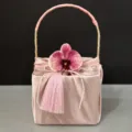 Pink satin gift box detail view featuring orchid flower pearl string and tassel design for wedding. - Pink Baskets