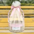 Elegant hand-woven round gift basket with pink ribbon bow and white tulle covering - Basket With Cream Mesh And Ribbon / Elegant Pink
