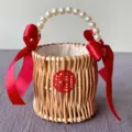 Detailed view of handmade woven rattan wedding gift basket with elegant pearl handle - Red Wedding Round Basket