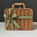 Detailed view of a handmade brown woven gift basket box with elegant green ribbon. - Medium Size 26x17x11cm / Grass Green Ribbon + Suitcase Box