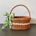 Detailed view of the plastic woven storage basket featuring brown and white rattan design. - Large Size [30x20x15] / Basket + Green Cotton Scarf (Self-Tie)