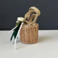 Detailed close-up of a handmade woven straw basket with jute rope handles and floral decor. - 10*10cm / Green Flower Basket