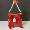 Woven basket gift box with elegant pearl handle and red satin bow for wedding party. - Diameter 16*Height 14.5 / Wine Red Straw Baskets with Pearl Chains