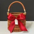 Round woven wicker bridesmaid gift basket featuring a large red bow handle and decorative pearl tag. - Diameter 16*Height 14.5 / [Wine Red] Leather Chain Basket Bag