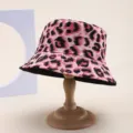 Detailed macro view of pink leopard print bucket hat on a wooden stand. - Adult 55-58cm / Leopard Print (Reversible) / Leopard Pink