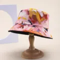Close-up of reversible bucket hat with artistic pink floral print and wide brim - Pink Purple Abstract Floral