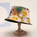 Macro view of colorful floral print bucket hat displayed on a professional wooden hat stand - Colorful Floral Print