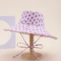Pink wide-brim bucket hat featuring a cute blue heart print, foldable sun protection beach cap. - Heart Pink