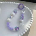 Exquisite sweet purple and white beaded phone strap featuring hand-painted floral charms - Purple White