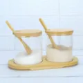 Glass condiment jar detail showing clear storage containers with wooden spoons and tray. - Rounded Corner Bamboo Bases 2-Pack / EPE Foam Packaging