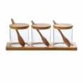 Transparent glass seasoning jar set with wooden tray and spoons for kitchen spice storage. - Square Corner Bamboo Bases 3-Pack / EPE Foam Packaging