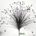 Detail showing the radial black stems and delicate leaf tips of artificial peacock grass - 70cm Length / Black
