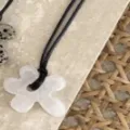 Elegant white flower shaped pendant necklace with a minimalist black cord detail - White Flower