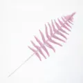 Close-up of pink glittery Persian leaf with intricate hollow design for Christmas - Pink