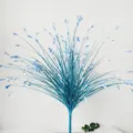 Detailed macro view of blue artificial glitter peacock grass onion leaf for wedding decoration. - Blue