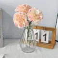 Artificial pink carnation flower arrangement in a clear glass vase for home decor - Peach Pink