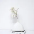 Flocked artificial silver leaf chrysanthemum in a minimalist white ceramic vase. - Thick Rod / White