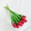 Close-up of red artificial tulips with realistic hand-feel texture and green leaves - Red
