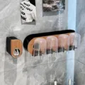 Wall-mounted toothbrush holder with 4 fluted cups in black and wood grain finish. - 4-Cup + Dispenser Set / Combo 4-Cup Set Walnut