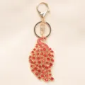 Vintage gouden pauw sleutelhanger met rode fonkelende strass steentjes voor tas. - Rood