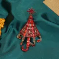 Vintage style red umbrella brooch with sparkling rhinestones and snowflake charm detail - Red