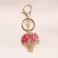 Sparkling flower basket keychain with red and pink rhinestones on a gold frame - Red
