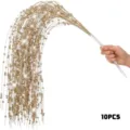 Close-up of 10 golden glitter willow branches being held for Christmas decoration - 10 Pieces/Pack / Gold
